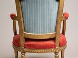 an image of a blue and gold chair with a red cushion
