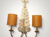 a pair of brass sconces mounted on a wall with lamps