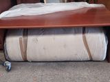a bed that is sitting under a table in a room