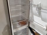 an open refrigerator that is sitting in the corner of a room