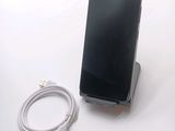 a cell phone that is sitting on top of a stand
