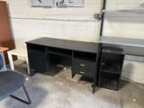 two desks and a chair in a room