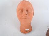 a clay sculpture of a man ' s head on a table