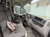 the interior of a van with the door open and the driver ' s seat down