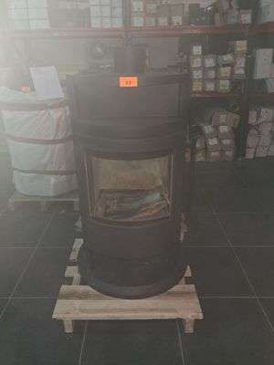 a black stove sitting on a pallet in a store