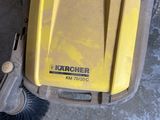 a yellow and black sweepr on the floor next to a brush