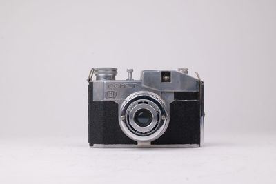une photo en noir et blanc d'un appareil photo sur une surface blanche