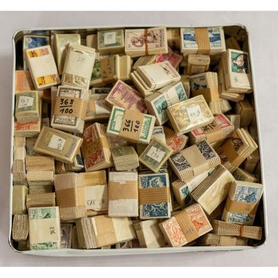 a metal box filled with stamps and stamps