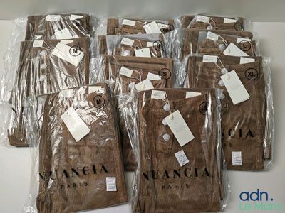 six pairs of brown pants are wrapped in plastic bags on a table