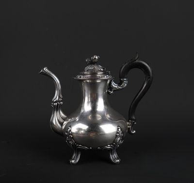 an antique silver teapot on a stand against a black background