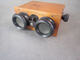 a small wooden box with two binoculars on top of it