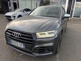 a grey audi suv parked in front of a building