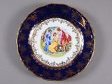 a blue and gold plate with a painting on it