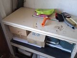 a small desk with a lot of clutter on top of it