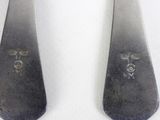 pair of silverware spoons with a design on them