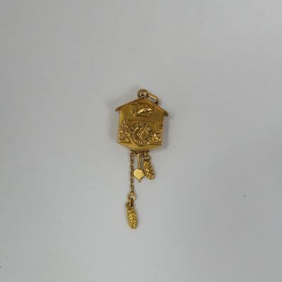 an image of a gold cuckoo clock hanging on a white wall