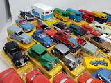 a lot of toy cars and trucks on a table