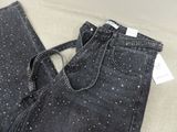 the back of a pair of black jeans with white stars on them