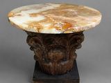 a marble table with a wooden base on a gray surface
