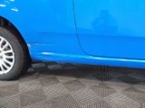 a blue car that is parked on the side of the road