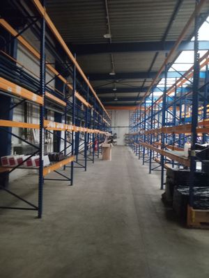 a large warehouse with lots of shelves and pallets