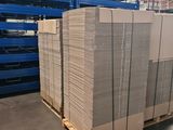 pallets stacked on pallets in a warehouse with pallets in the background