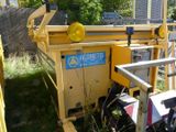 a yellow machine that is sitting in the grass