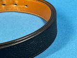 black and brown leather belt on a blue background
