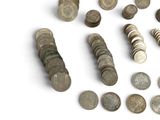 a lot of coins that are on a white surface