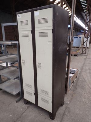 two metal lockers in a warehouse next to each other