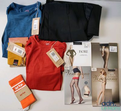 beaucoup de vêtements et un livre posés sur une table