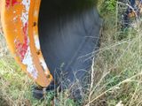 a yellow bulldozer that is sitting in the grass