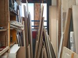 many pieces of wood stacked up in a room