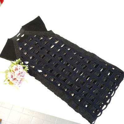 a black bag with a flower on it sitting on a table