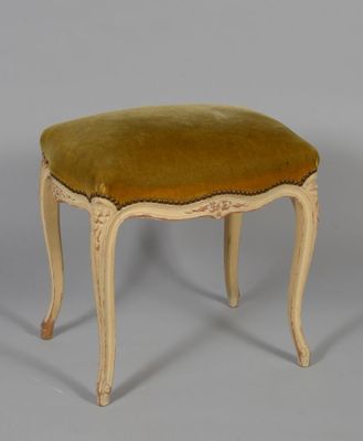 an image of a small stool with a green velvet seat