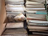 a box filled with lots of old papers on the floor