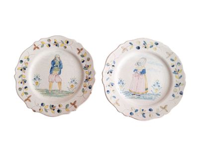 two plates with a painting of a man and a woman on them