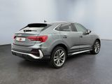 the rear end of a silver 2020 audi qx