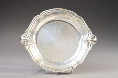 an antique silver plate on a stand on a gray background