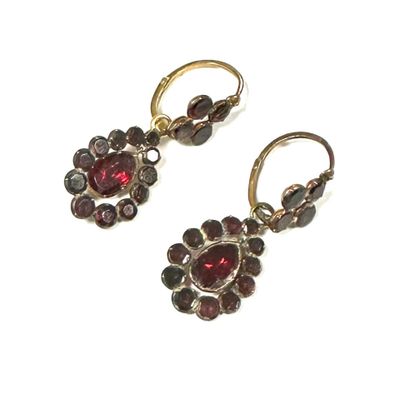 an image of a pair of earrings with garnets on them