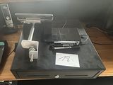 an image of a cash register on a desk with a pen and a cell phone