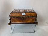 a small wooden box on a glass stand