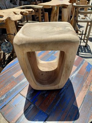 a wooden chair sitting on top of a wooden table
