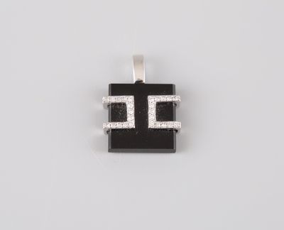 a black and white pendant with diamonds on a white background
