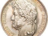 une vieille pièce d'argent avec un visage de femme dessus