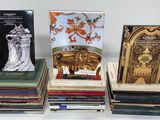 several books are stacked on top of each other on a table