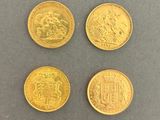four gold coins with different designs on them on a gray surface
