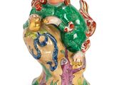 an image of a figurine of a man with a fish on his back
