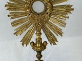 gold plated crucift with a cross on top of it