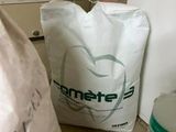 a bag of toilet paper next to a bag of toilet paper on the floor